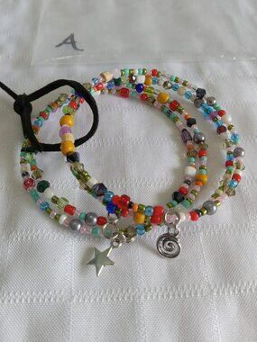 A- Handmade memory wire bracelets set with beads and pendants